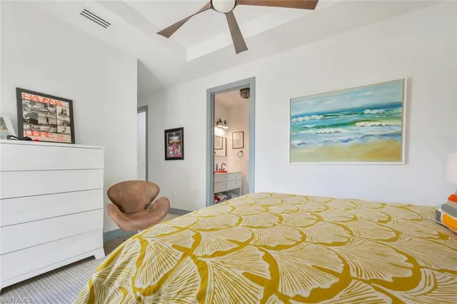 a bedroom with a bed and a painting on the wall