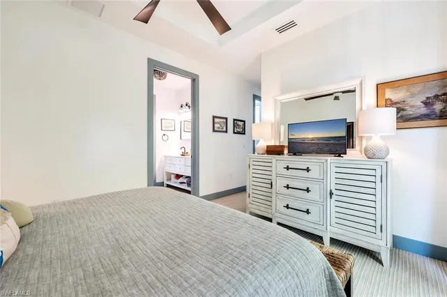 a bedroom with a bed and flat screen tv