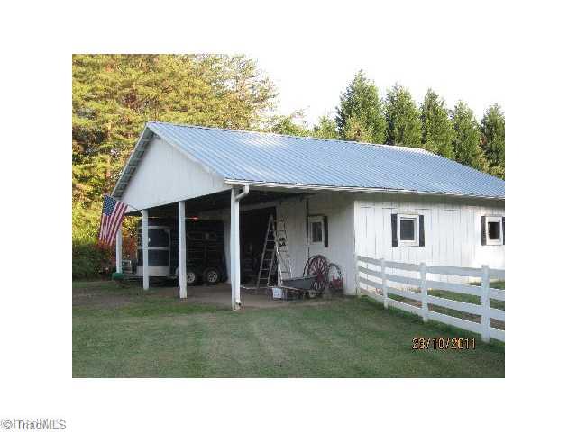 7926 Highfill Road Summerfield, NC 27358 - Photo 3 of 6 Outbuilding. The custom built barn makes life easy. Set up for convenience and safety. Three 12x12 stalls plus a tack room. Lots of room for expansion.