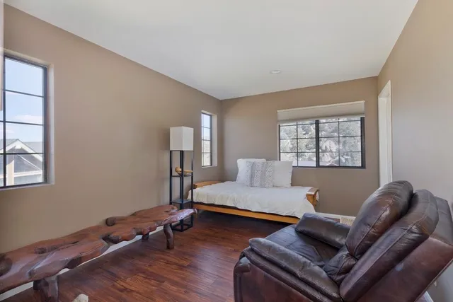 a bedroom with bed couch and window