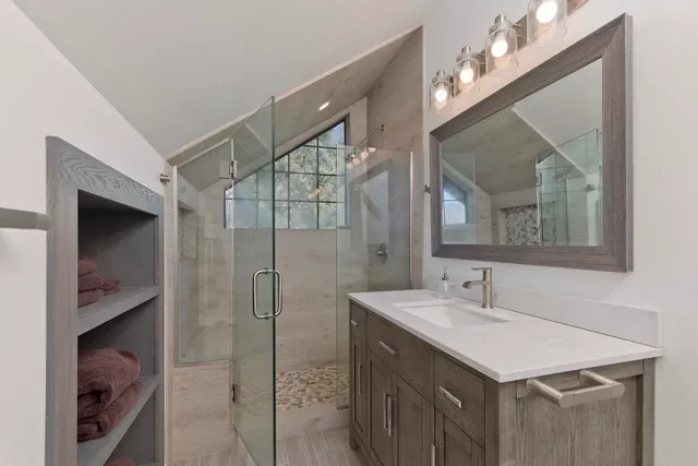 a bathroom with a sink vanity and a mirror