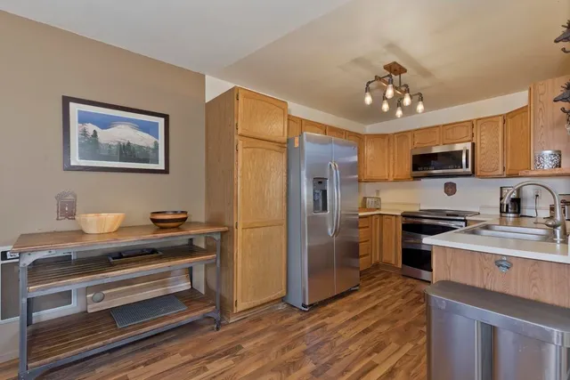 a kitchen with stainless steel appliances a stove refrigerator and microwave