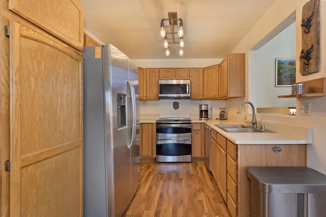 a kitchen with stainless steel appliances granite countertop a refrigerator stove and sink