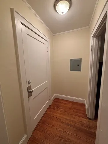 a view of a room with wooden floor