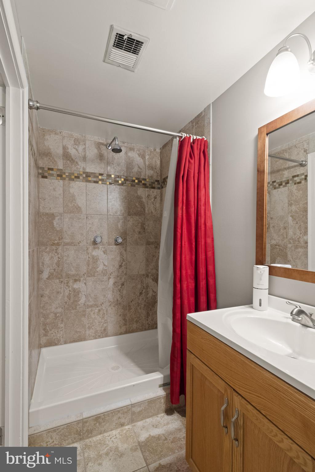 8573 Tyrolean Way Springfield, VA 22153 - Photo 31 of 32 a bathroom with a shower curtain and a sink