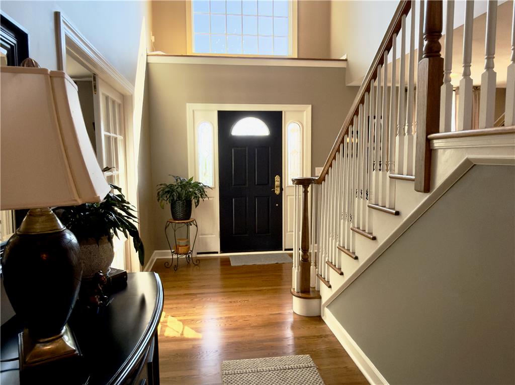 4982 Abbey Road Coplay, PA 18037 - Photo 5 of 55 Soaring ceilings and rich hardwood flooring frame a welcoming entryway featuring a classical staircase.