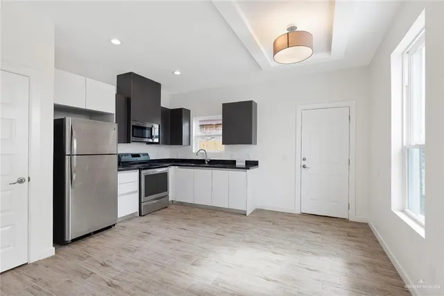 a kitchen with a refrigerator and a sink