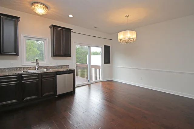 a large kitchen with lots of counter space a sink and dishwasher