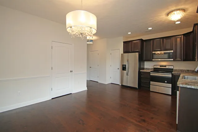 a view of kitchen with stainless steel appliances refrigerator and stove