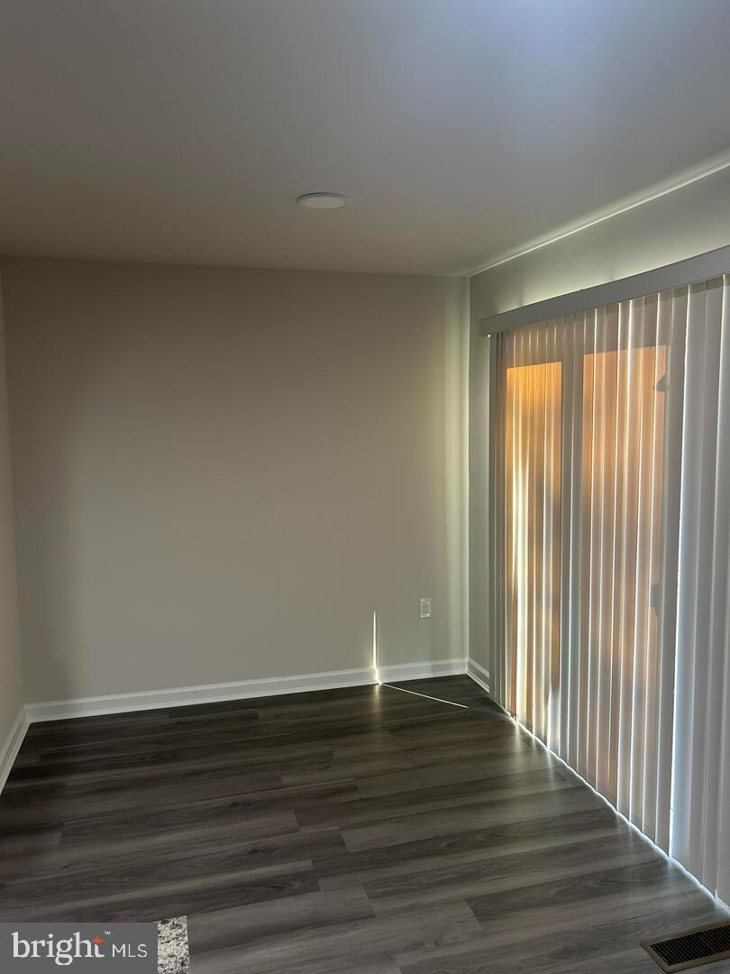 224 Lady Bug Drive Dover, DE 19901 - Photo 12 of 13 a view of an empty room with wooden floor and a window