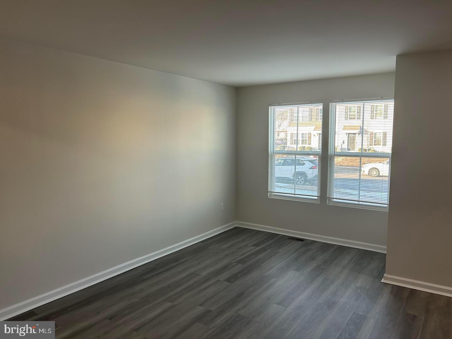 224 Lady Bug Drive Dover, DE 19901 - Photo 3 of 13 an empty room with wooden floor and windows