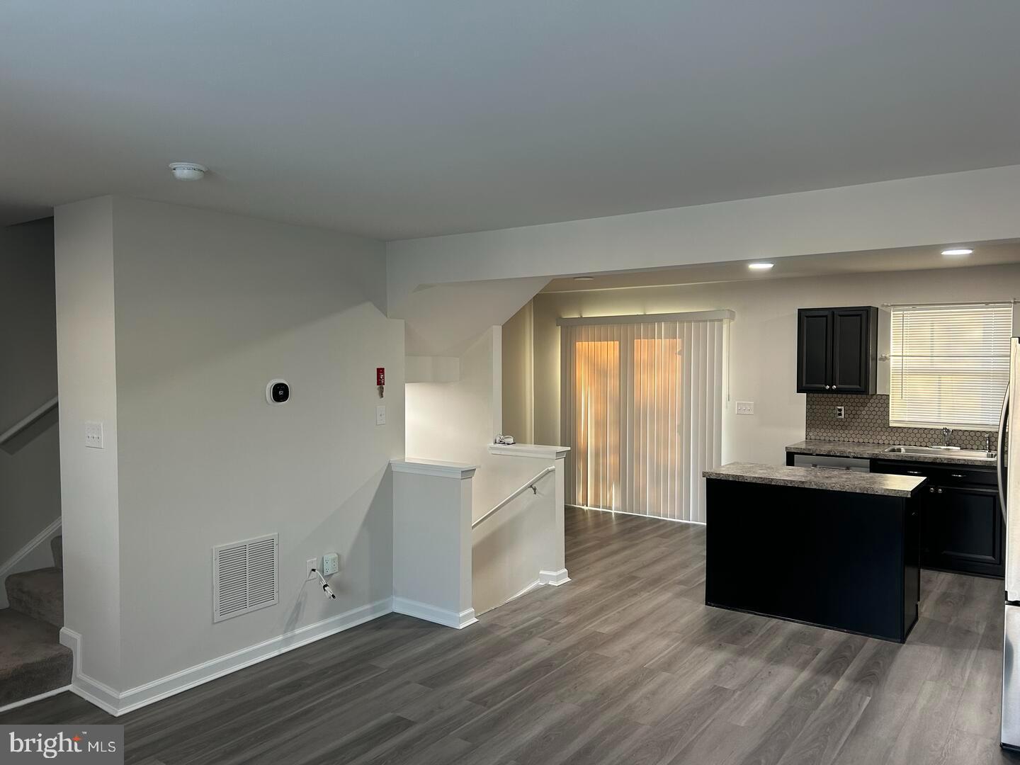 224 Lady Bug Drive Dover, DE 19901 - Photo 4 of 13 a large kitchen with cabinets and wooden floor