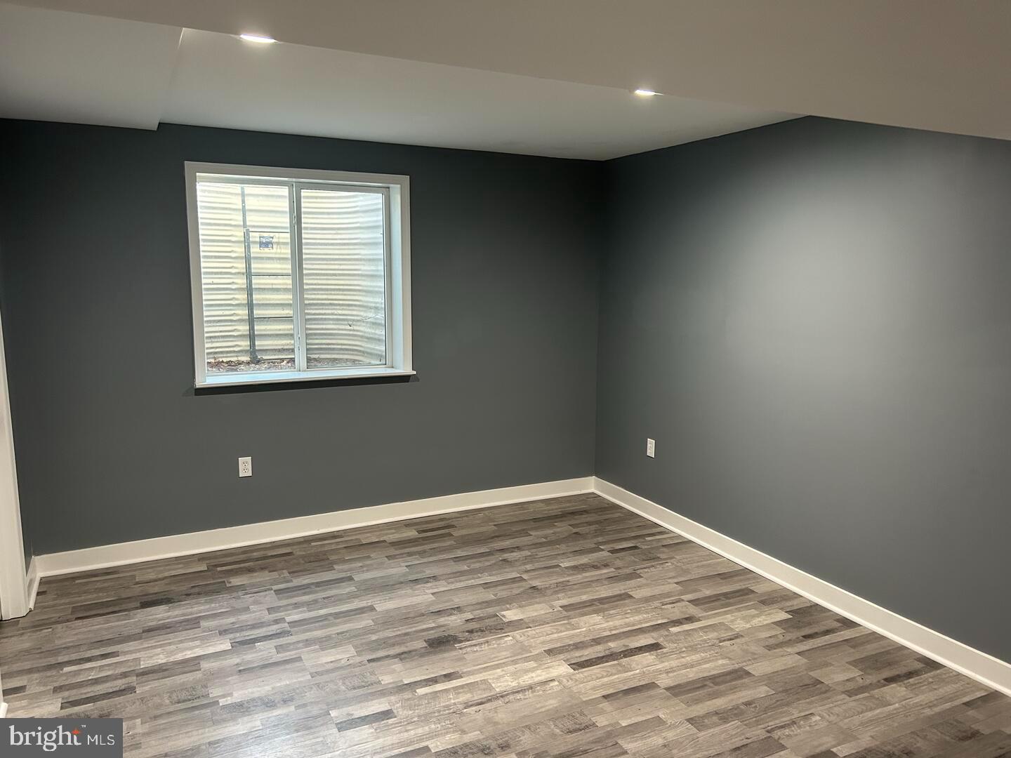 224 Lady Bug Drive Dover, DE 19901 - Photo 6 of 13 an empty room with wooden floor and windows
