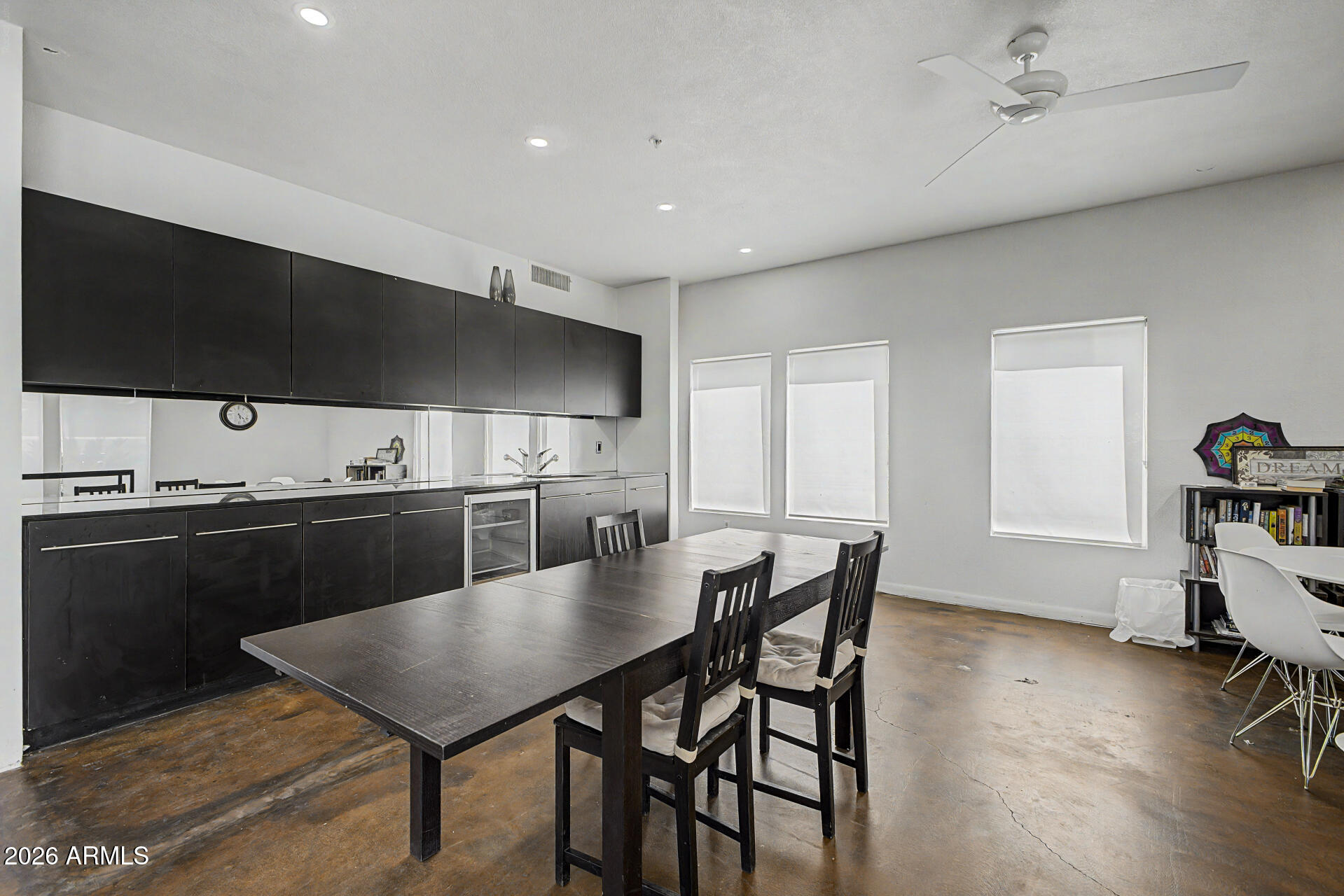 1295 North Ash Street, Unit 828 Gilbert, AZ 85233 - Photo 41 of 43 a kitchen with a table chairs and a refrigerator