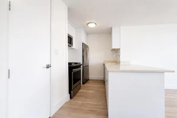 a kitchen with a refrigerator and a sink