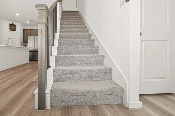 a view of staircase with white walls and stairs