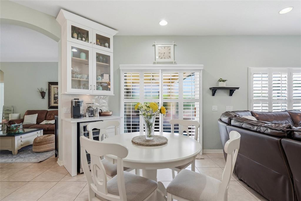 16748 Midsummer Lane Spring Hill, FL 34610 - Photo 19 of 52 a kitchen with stainless steel appliances granite countertop a stove a sink a table and chairs