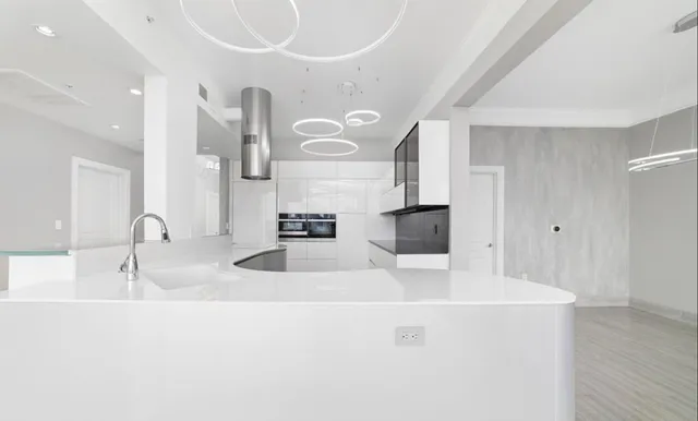 a kitchen with stainless steel appliances and white cabinet