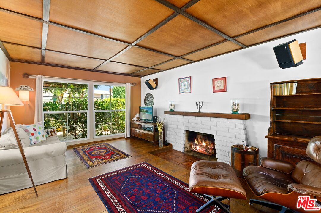5101 Lindblade Drive Culver City, CA 90230 - Photo 3 of 11 a living room with furniture a flat screen tv and a fireplace