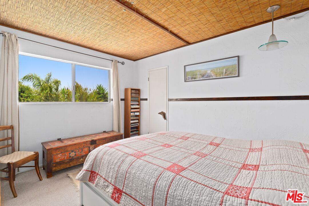 5101 Lindblade Drive Culver City, CA 90230 - Photo 8 of 11 a bedroom with a bed and a painting on the wall