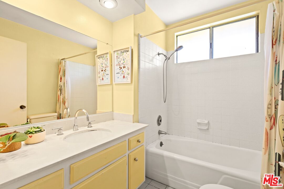 5101 Lindblade Drive Culver City, CA 90230 - Photo 9 of 11 a bathroom with a tub sink and mirror