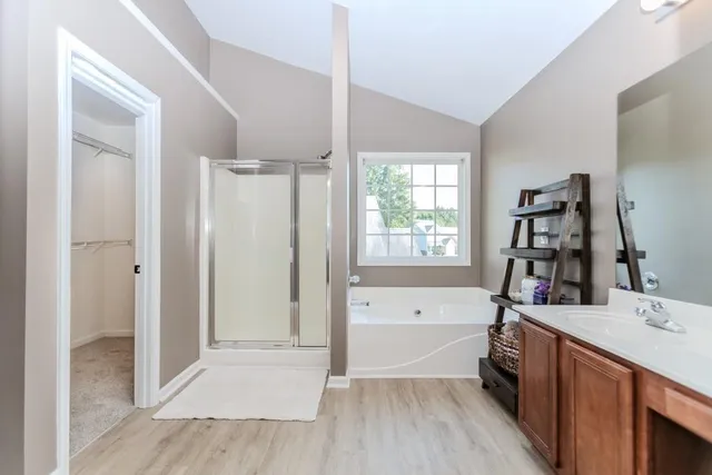 a bathroom with a tub sink and a mirror
