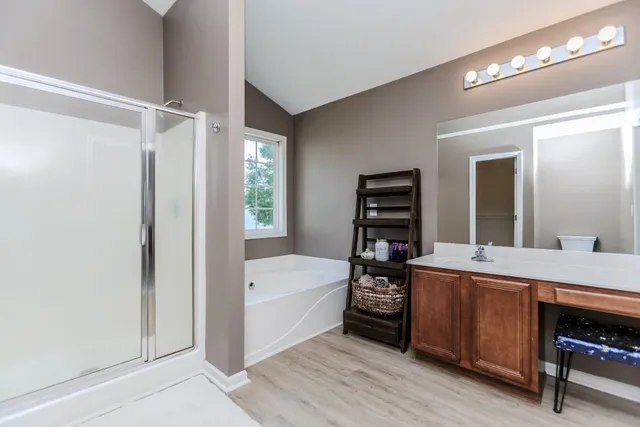 a room with a bed and a mirror on a dresser