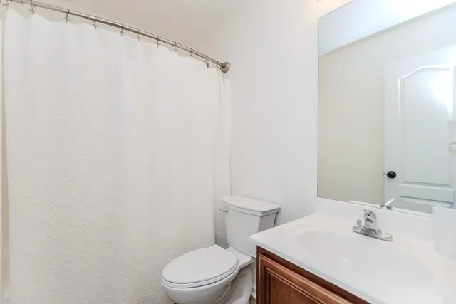 a white toilet sitting next to a bathroom sink