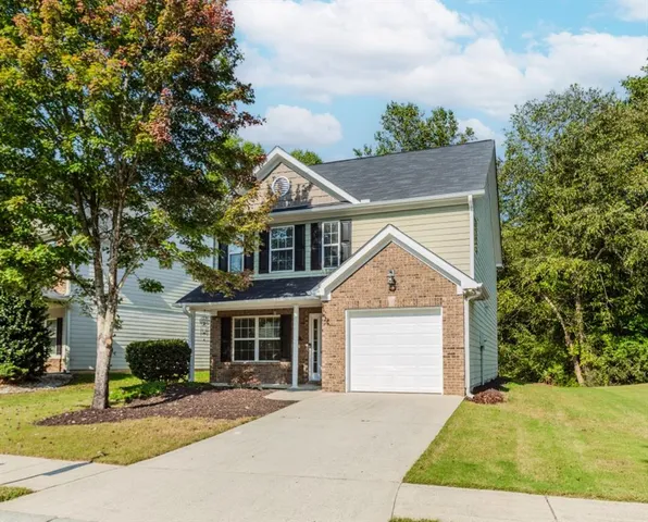 a front view of a house with a yard and garage