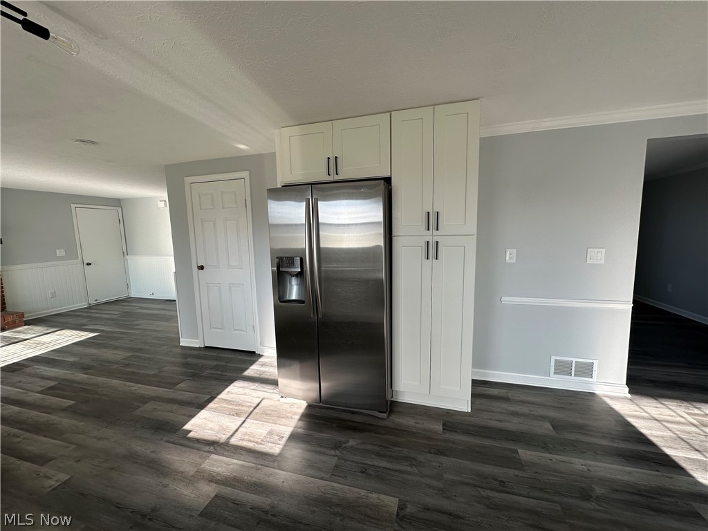 16213 Drake Road Strongsville, OH 44136 - Photo 6 of 28 Kitchen featuring white cabinets, a textured ceiling, stainless steel refrigerator with ice dispenser, and dark wood-type flooring