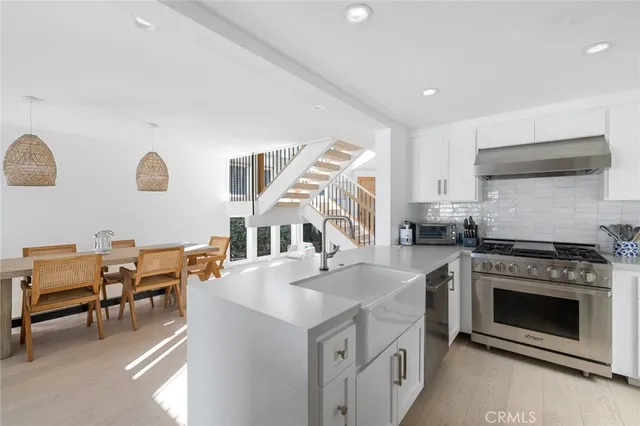 a kitchen with stainless steel appliances granite countertop a stove and a sink