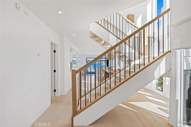 a view of staircase with lots of windows and white walls