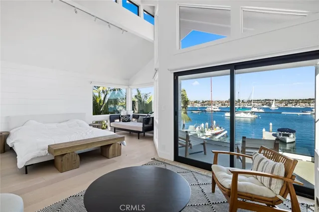 a bedroom with furniture and a large window