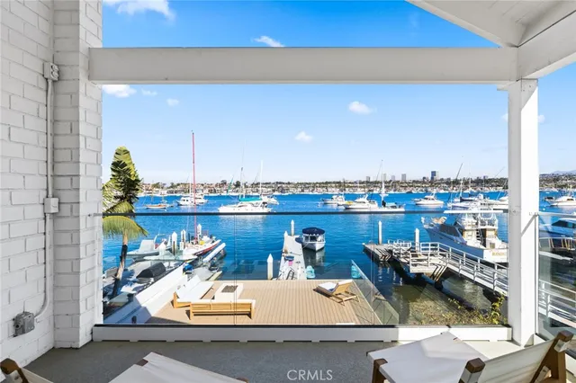 a view of a lake with couches chairs and city view