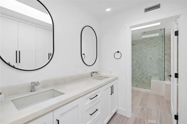 a bathroom with a double vanity sink and a mirror