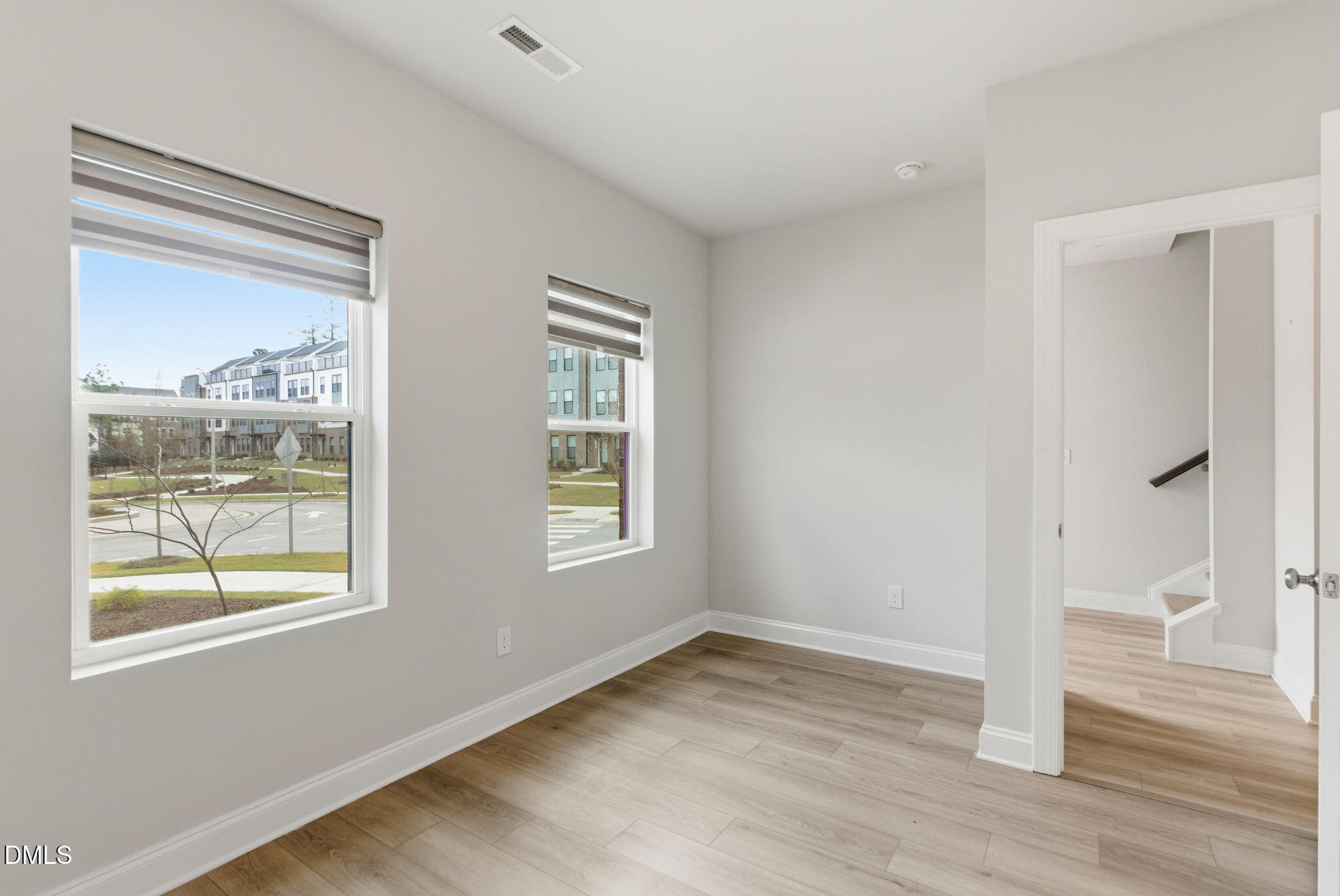 501 Hedrick Ridge Road Cary, NC 27519 - Photo 5 of 47 a view of an empty room with wooden floor and a window