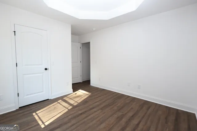 a view of wooden floor and windows in a room