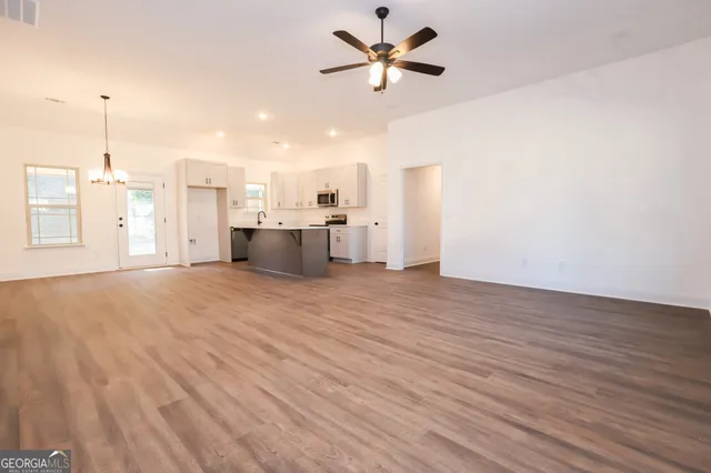 a view of a kitchen with furniture and a ceiling fan