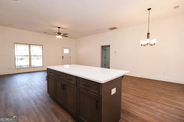 a kitchen with a sink and chandelier