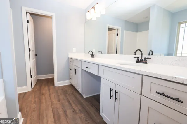 a spacious bathroom with a double vanity sink and mirror