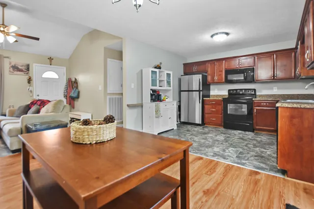 a living room with dining room and wooden floor
