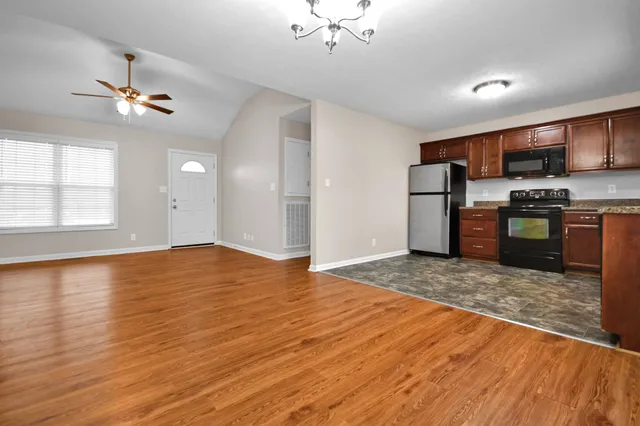 a view of a kitchen with a stove cabinets and wooden floor