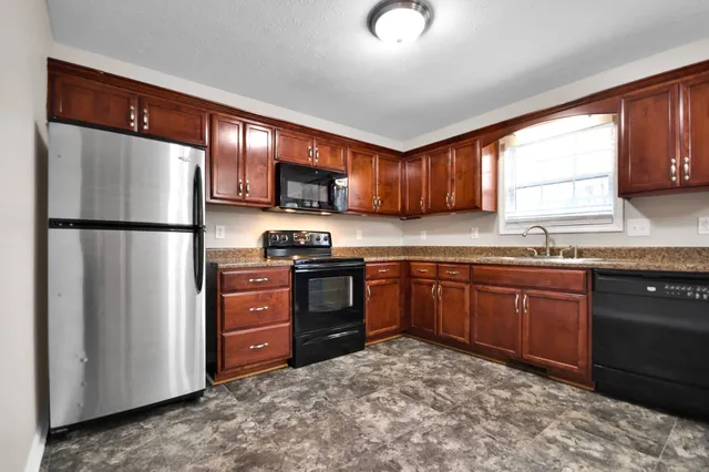 a kitchen with a refrigerator stove and sink