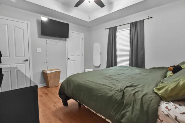 a bedroom with a bed and a flat screen tv