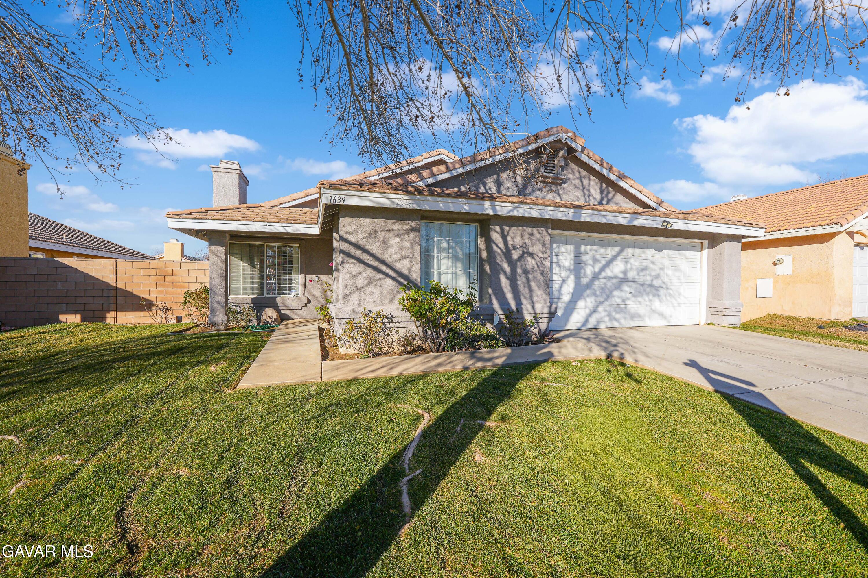 1639 East Kettering Street Lancaster, CA 93535 - Photo 2 of 35 a view of a house with a yard and furniture