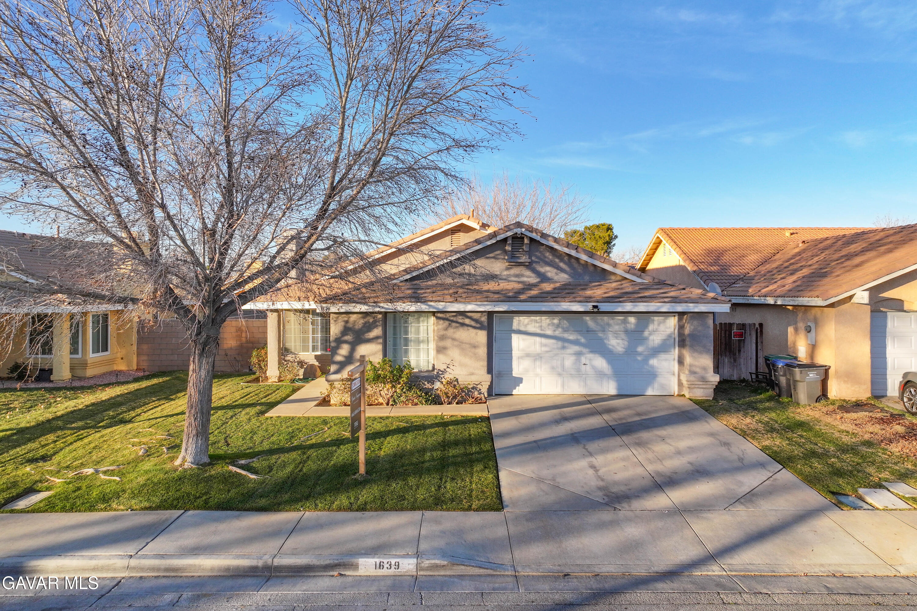 1639 East Kettering Street Lancaster, CA 93535 - Photo 32 of 35 a front view of a house with a yard