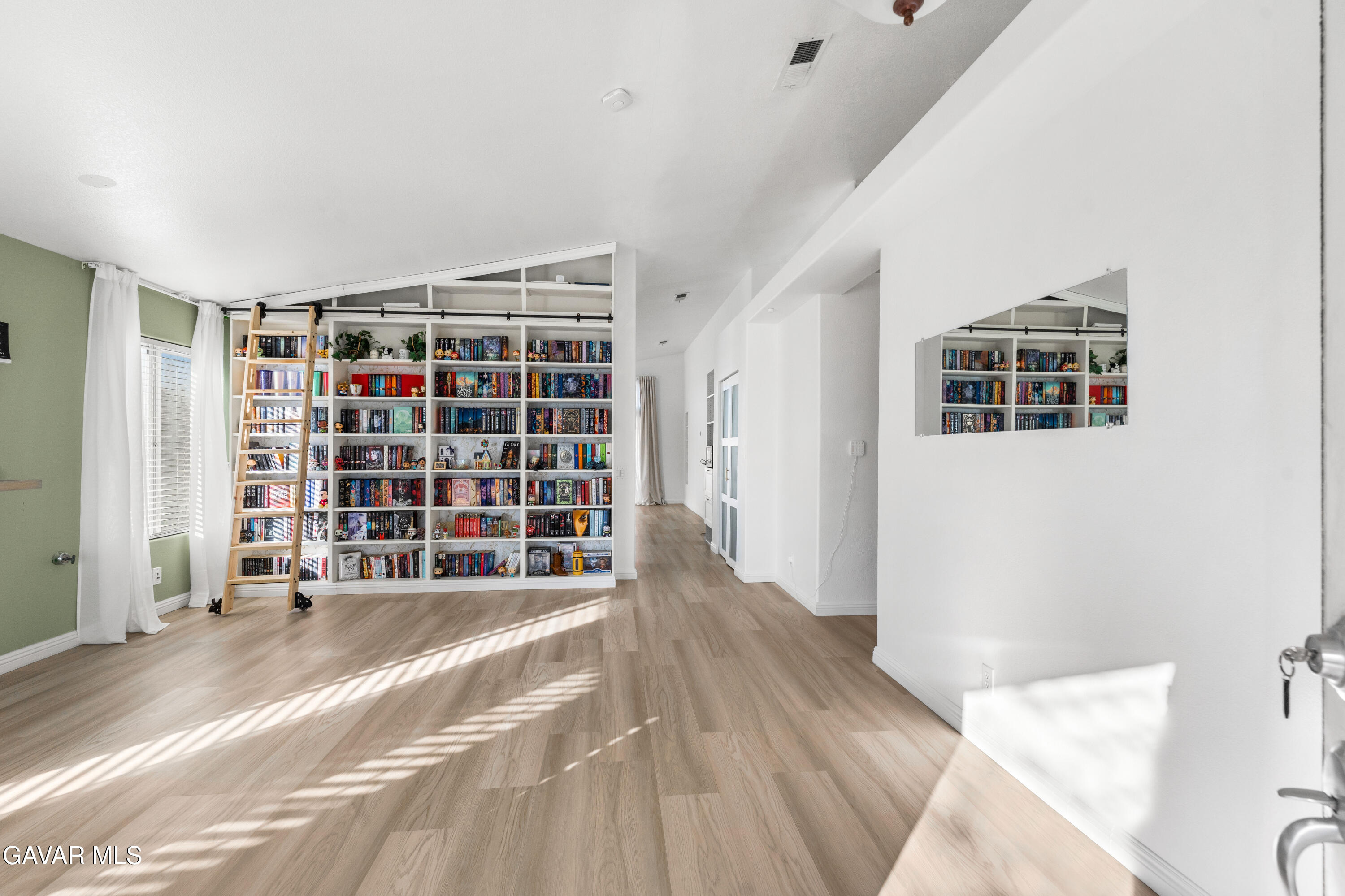 1639 East Kettering Street Lancaster, CA 93535 - Photo 4 of 35 a view of empty room with wooden floor and closet