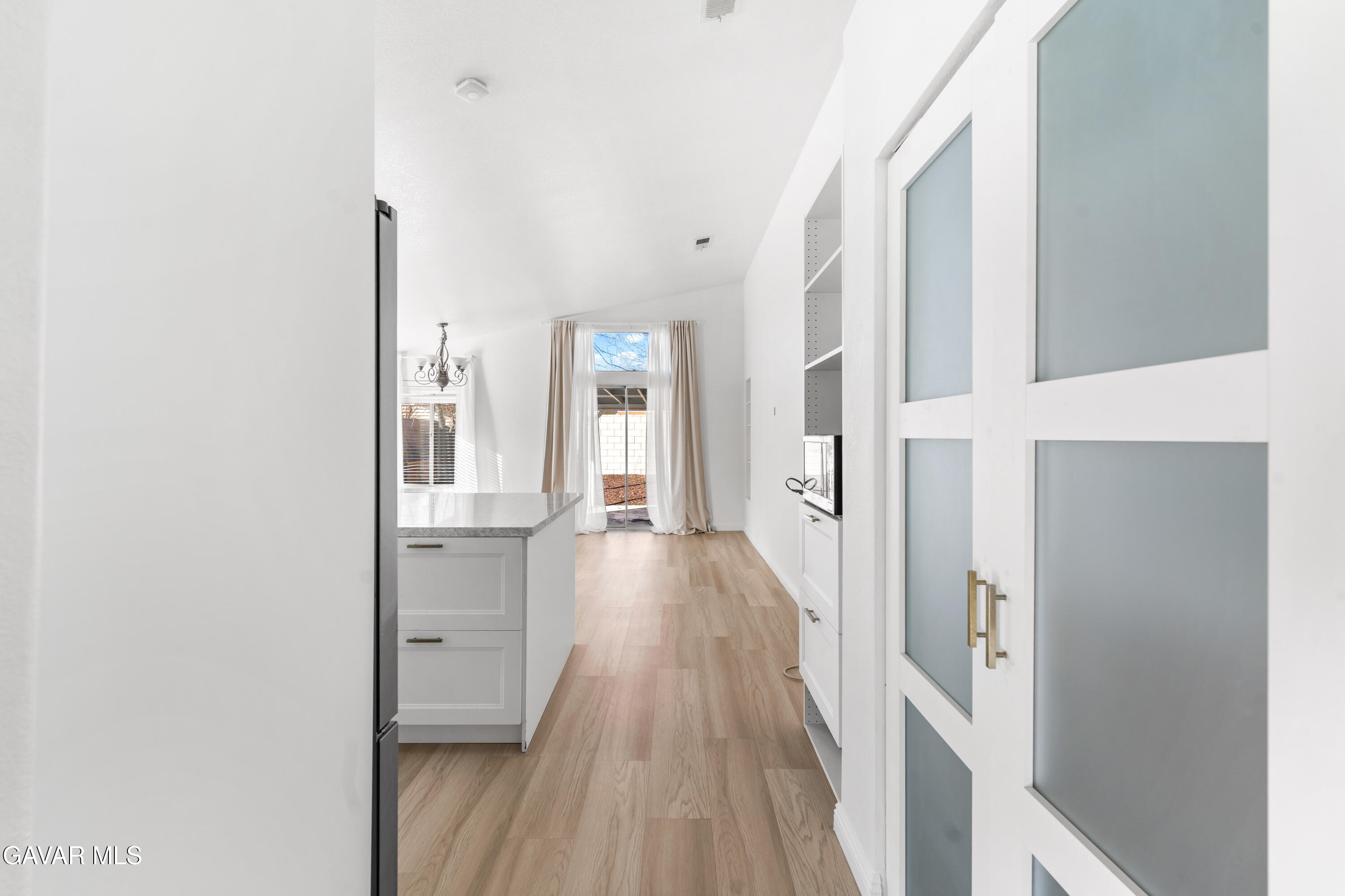 1639 East Kettering Street Lancaster, CA 93535 - Photo 9 of 35 a view of a hallway with wooden floor and staircase