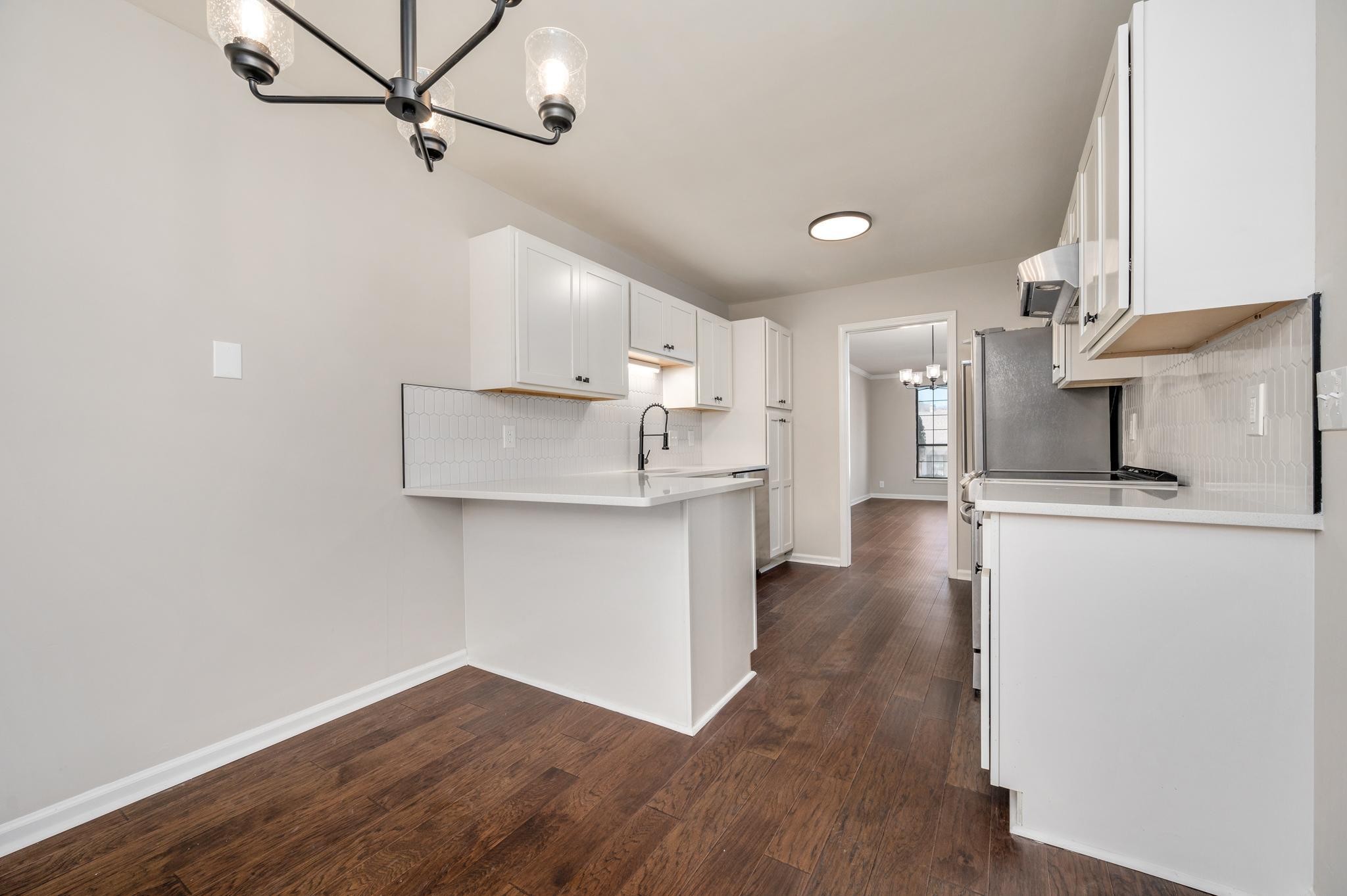 946 General George Patton Road Nashville, TN 37221 - Photo 8 of 31 a view of a kitchen with a sink and dishwasher a refrigerator with wooden floor