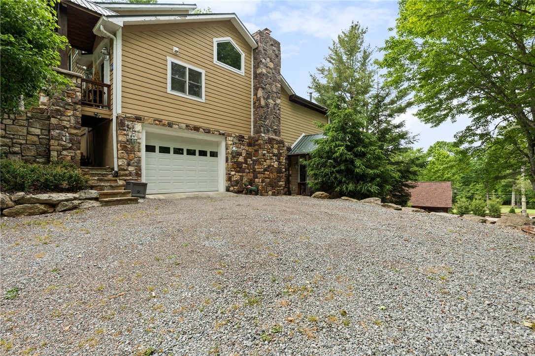 123 St Andrews Road Beech Mountain, NC 28604 - Photo 49 of 50 a view of a house with a yard and garage